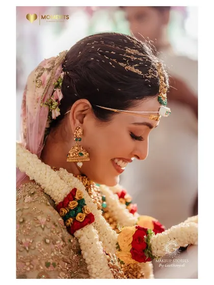 A candid, happy moment from Ashitha's wedding ceremony. The soft, natural makeup ensures she looks radiant and feels comfortable throughout her big day.