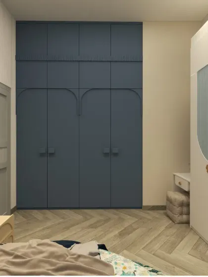 A full-height blue wardrobe with custom curved handles provides ample storage while adding a pop of color to the room.