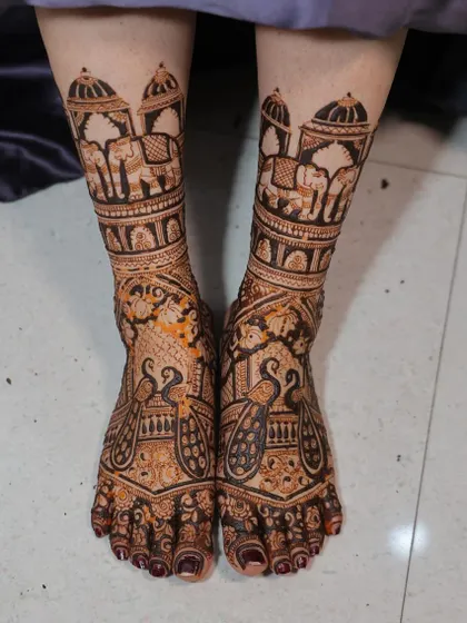 Bridal feet deserve just as much love. I created this symmetrical design featuring royal elephants under a jharokha and elegant peacocks, ensuring the bride looks perfect from head to toe.