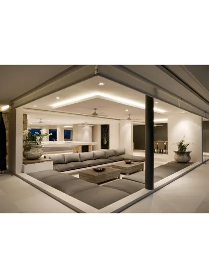 This sunken lounge area is a unique feature we designed for a client seeking a cozy and intimate gathering space. The low seating and warm, indirect lighting create a relaxed and modern conversational pit.