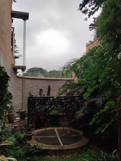 A quiet corner of the Sunyata Hotel, featuring a traditional well in a courtyard garden, connecting the design to local heritage and sustainable practices.