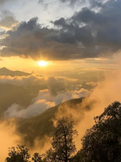 A breathtaking sunset over the clouds in the mountains. Capturing nature's beauty is one of my favorite parts of travel content creation.