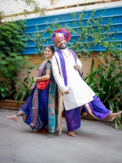 A fun and playful back-to-back pose, showing the couple's joyful and lighthearted connection.