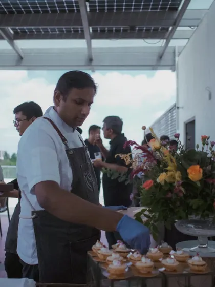A shot of me at an event, carefully arranging canapés on a platter.