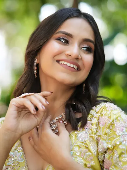 A happy, glowing moment. The soft makeup enhances her natural beauty, making her smile the centerpiece of the look.