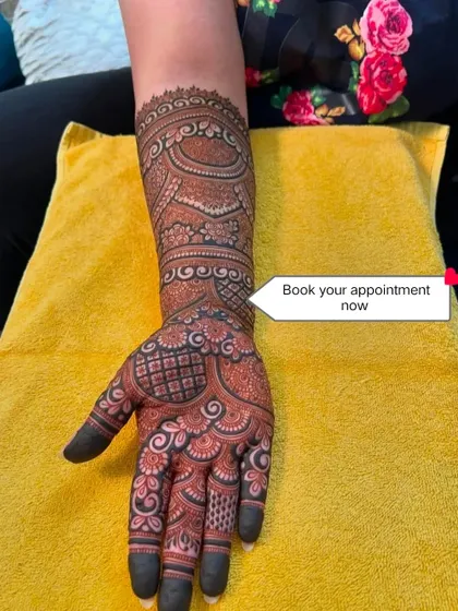 This is a classic Marwadi style bridal mehndi, known for its fine lines and detailed figures. The patterns are dense and cover the entire hand and arm.
