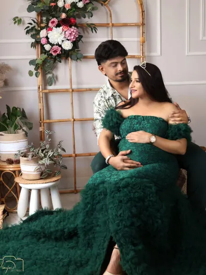 A close-up of the couple's loving gaze. The dark green gown adds a touch of sophisticated color to the boho setup.