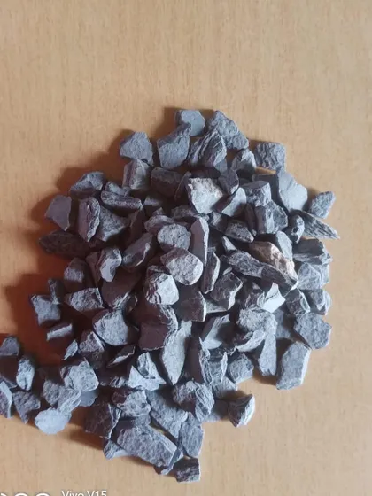 A pile of dark grey, unpolished stone chips.