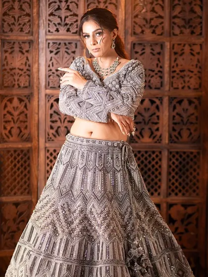 This full-length shot captures the commanding presence of the silver-grey lehenga. It’s a powerful and confident look.