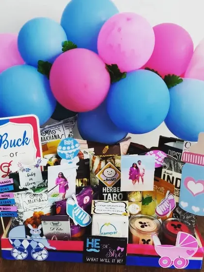 Buck or Doe? This gender reveal hamper is filled with snacks and decorated with pink and blue balloons and signs. It's a fun way to build excitement for the big reveal.