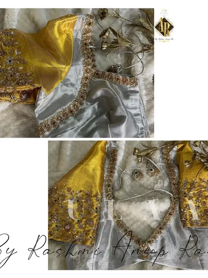 A silver tissue blouse with heavy gold embroidery on the sleeves. The back features a sheer panel, combining traditional work with a modern silhouette.