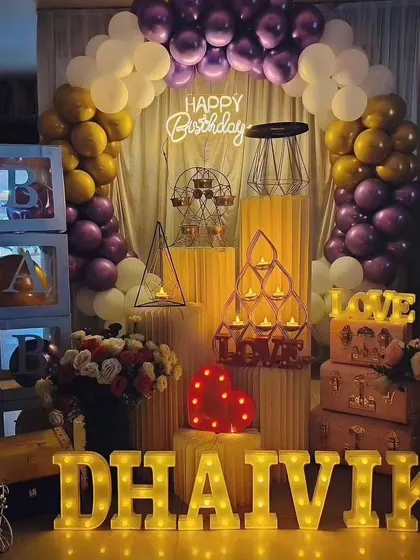 Another view of our popular purple and gold birthday package for 'Dhaivik', showcasing the full arrangement with 'BABY' blocks and decorative props.