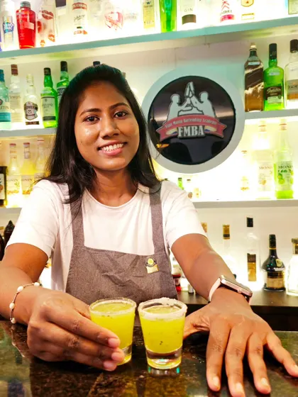 Our award-winning female mixologist, Kavita, with her signature kiwi shots. She brings creativity and world-class skill to every event.