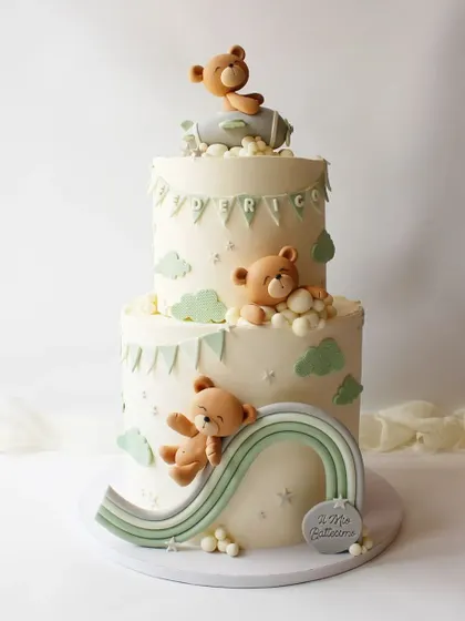 A beautiful two-tiered cake with sleeping teddy bears, a rainbow slide, and an airplane. This dreamy design is perfect for a baby's baptism or first birthday.