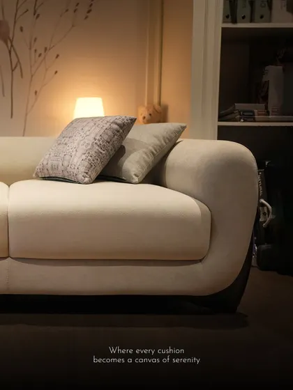 A serene shot of the Soco sofa, where every cushion becomes a canvas of serenity. The gentle curves and soft fabric invite relaxation.