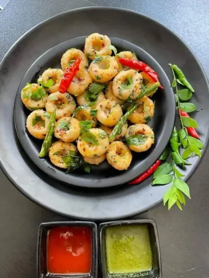 A delicious and savory South Indian snack. These mini rice flour rings are lightly spiced and served with red and green chutneys, offering a unique taste.