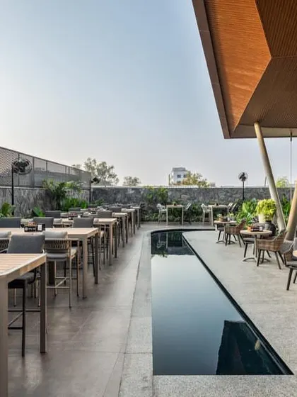 'Terns', a restobar in Coimbatore by Ksquare Architects, features an expansive outdoor terrace with a reflective water channel, seamlessly fusing architecture and landscape.