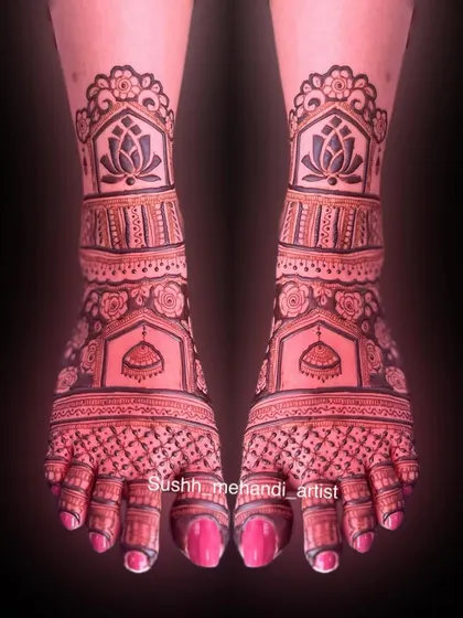 An edited shot of the lotus and jhumka foot design, highlighting the bold lines and symmetry against a dark background.