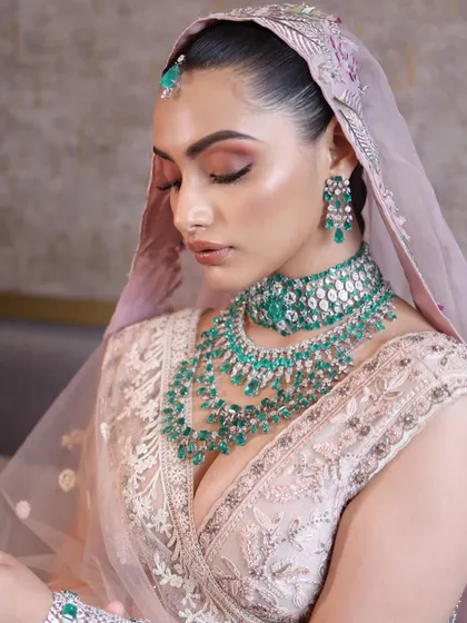 A soft, romantic bridal look with a focus on peachy and pink tones. This style is perfect for a daytime wedding, and I teach how to make it last all day while still looking fresh.