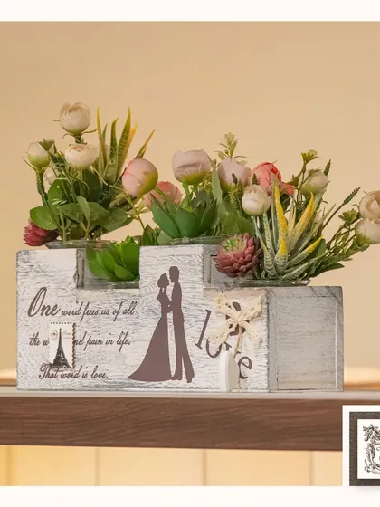 This rustic wooden box planter, filled with imitation florals and succulents, adds a touch of romantic charm to a shelf or table. The "love" inscription makes it a perfect gift.