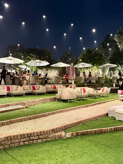 The view of our amphitheater seating from a distance, showing the scale and the beautiful arrangement under the night sky with string lights.