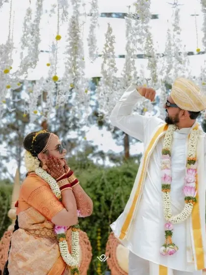 A fun and playful moment during the wedding ceremony, where the groom shows off for his amused bride.