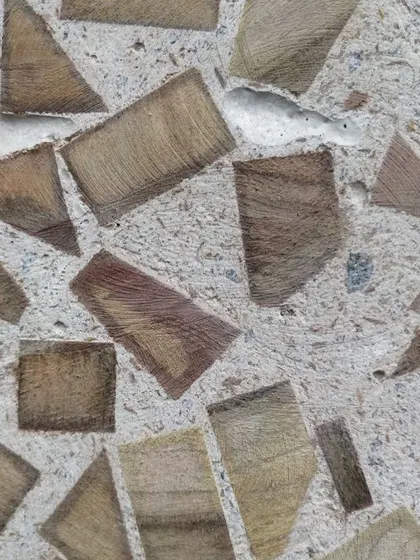 A close-up of the finished texture from our wood waste experiment. This process of discovery informs our designs for unique wall panels, furniture, and other custom elements.