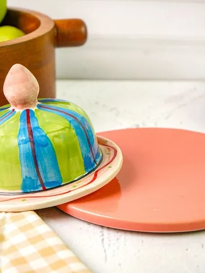 The butter dish styled on a kitchen counter, with the lid slightly ajar. This small detail makes the scene feel more natural and lived-in.