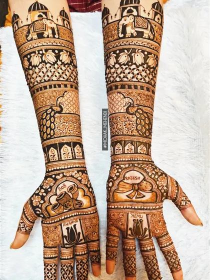 This is the kind of intricate bridal work that we are known for. This design features traditional motifs like elephants and palaces, combined with delicate floral patterns, covering the arms from elbow to fingertips.