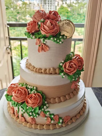 The full view of the stunning three-tiered anniversary cake, a perfect centerpiece for a landmark celebration.