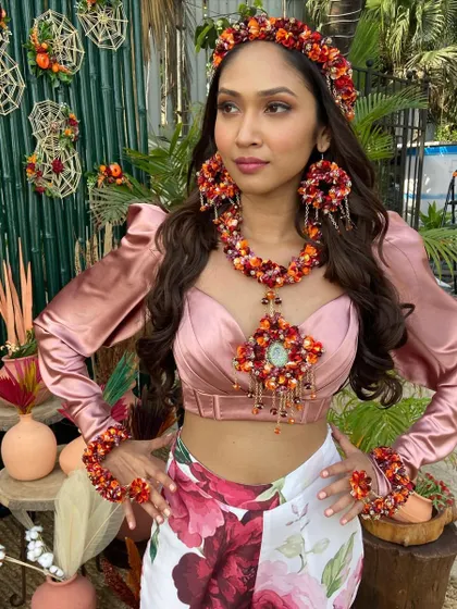 The complete look, with the bride adorned in beautiful floral jewelry from head to toe, her hair styled in complementary soft waves.