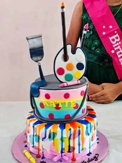 A close-up of the art-themed cake at the party, ready to be enjoyed.