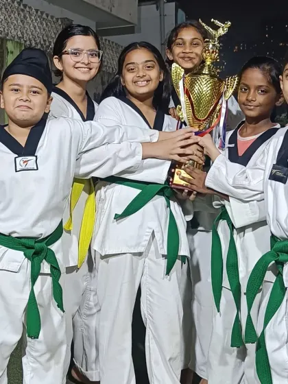 A group of our students celebrating with their trophy. The joy and camaraderie are what make our academy special.