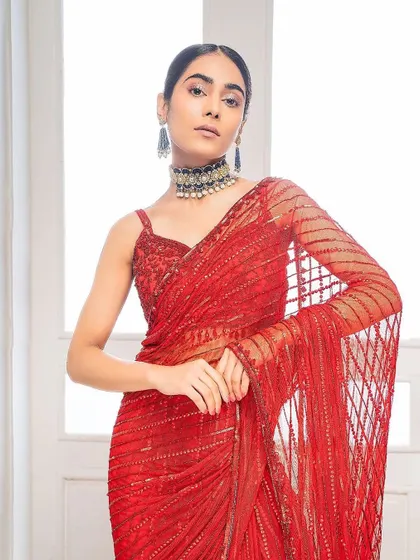 For this fashion shoot, I created a sleek, center-parted low bun. This hairstyle is elegant and clean, drawing all attention to the model's face and the stunning red saree.