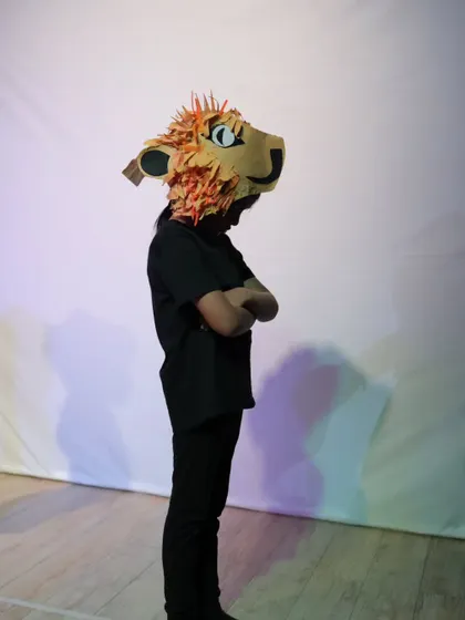 A student wearing the magnificent, handcrafted lion mask for our Narnia-inspired production.