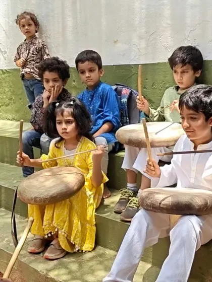 Children learn to play the parai, a traditional folk drum, during our Independence Day event. This is a hands-on lesson in the rich cultural heritage of India.
