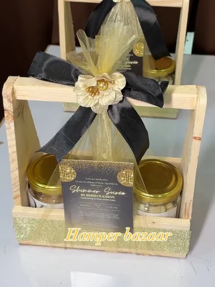 This "Shimmer Soirée" hamper was designed for a glamorous party. It features a chic black and gold theme with a personalized card, and we included jars of chocolates and a mini bottle of Absolut to match the celebration's vibe.