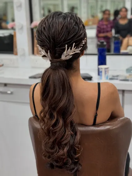 A full view of the chic wet-look ponytail, showcasing its sleek texture and beautiful wavy ends.