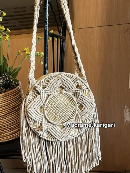 A variation of our round macramé bag in an off-white color. It’s a timeless piece that pairs well with everything, perfect for a day out or a beach vacation.