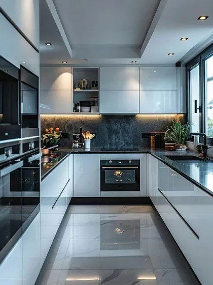 A sleek, futuristic U-shaped kitchen with high-gloss white cabinets and black accents. The reflective floor and ceiling lighting create a sense of depth and luxury.
