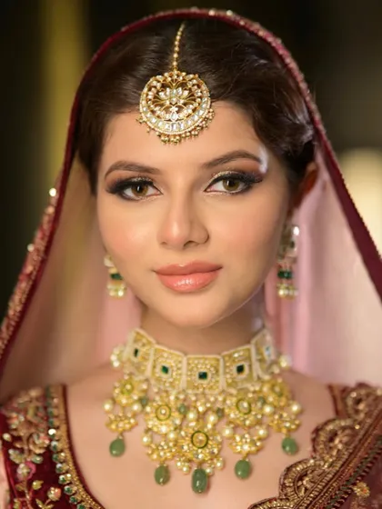 A close-up of this stunning modern bride. The look features a sharp, winged liner and a glossy nude lip, showing how to pair glam with a traditional silhouette.