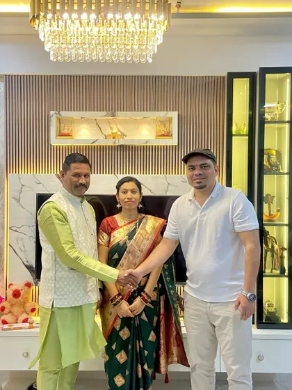 Shaking hands with Mr. Suryavanshi, marking the official handover of their beautiful 2BHK. A moment of mutual respect and gratitude.