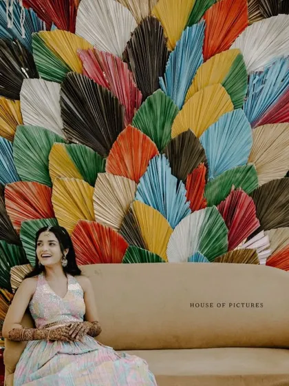 Another view of the stunning multi-colored palm leaf backdrop, a perfect choice for a modern and chic pre-wedding event.
