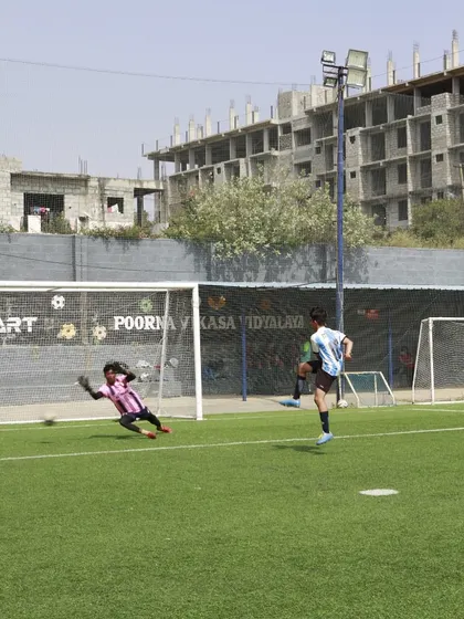 A goalkeeper makes a spectacular save during our football trials. We look for players who are ready to give their all and showcase their talent under pressure.