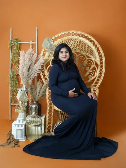 A regal portrait of a mom-to-be seated on our wicker peacock chair. This setup is a client favorite and creates a beautiful, bohemian-inspired look.