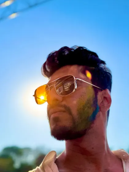 A sun-kissed portrait from the Holi festival. The colors on my face and the sun in the background perfectly capture the aesthetic of the day.