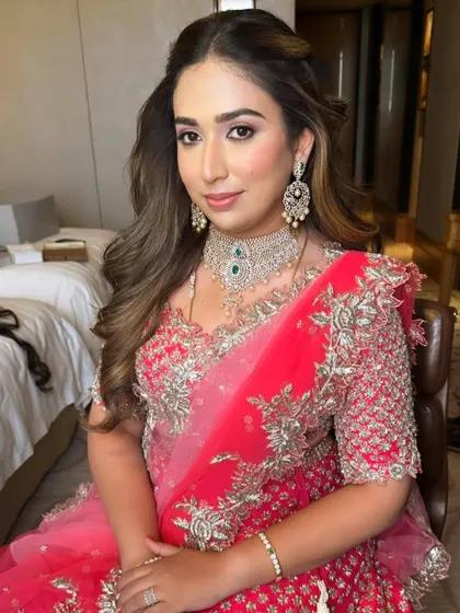 A poised shot showing the complete look with her beautiful diamond and emerald jewelry.