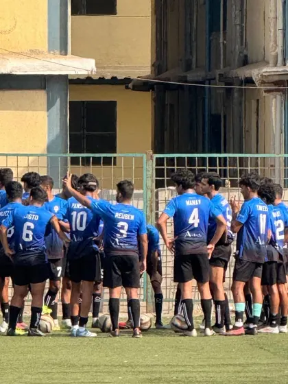 The team in a huddle, discussing strategy. Teamwork and communication are at the core of our coaching philosophy.