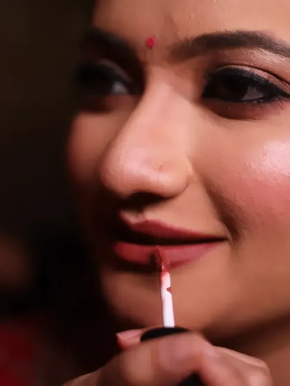 A detailed shot of lipstick application on a bride. Precision is key, and in my classes, I demonstrate how to achieve a perfectly defined lip shape that complements the entire bridal look.