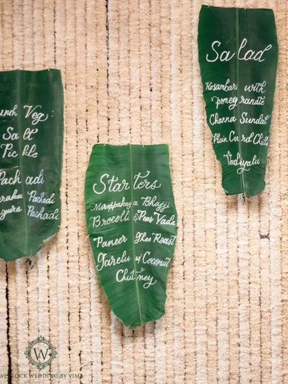 A creative and sustainable detail for a South Indian wedding. We used banana leaves with beautiful calligraphy as menu cards, adding an authentic and eco-friendly touch.